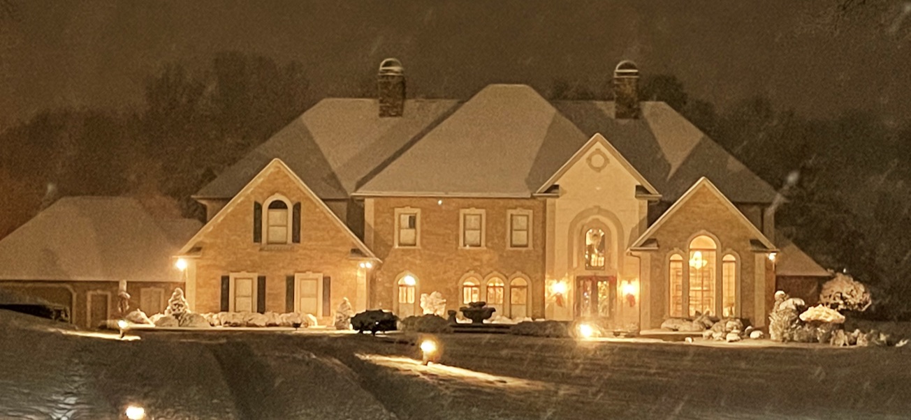 FairFax-built custom home at night in the snow